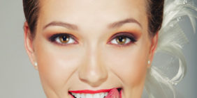 sexy young woman lick one’s lips on white background